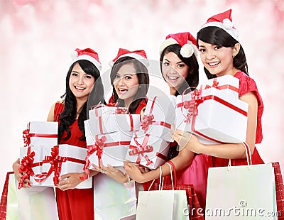 Happy funny people with christmas santa hat holding gift boxes a