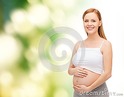 Happy future mother touching her belly