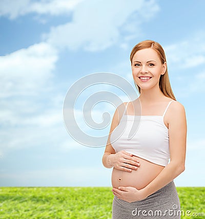 Happy future mother touching her belly