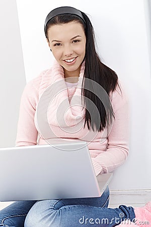 Happy girl browsing internet on laptop computer