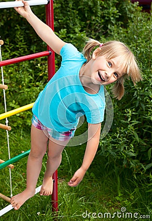 Happy girl on a jungle gym