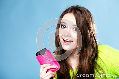 Happy girl with mobile phone in pink cover