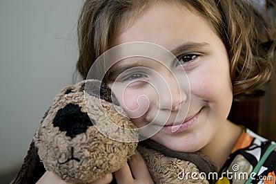 Happy girl with stuffed dog