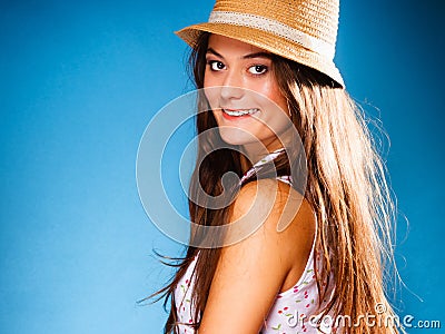 Happy girl in summer clothes and straw hat.
