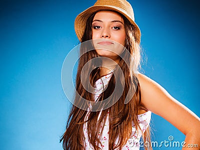 Happy girl in summer clothes and straw hat.