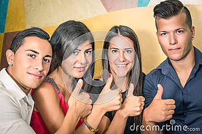 Happy group of friends with thumbs up