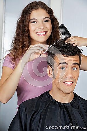 Happy Hairdresser Cutting Client s Hair At Salon