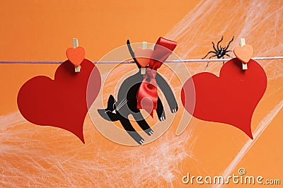 Happy Halloween blank message for your text here on red hearts and black cat with pegs hanging from a line