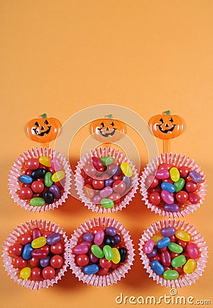 Happy Halloween trick or treat candy on bright colorful modern orange background