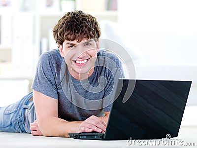 Happy handsome man with laptop