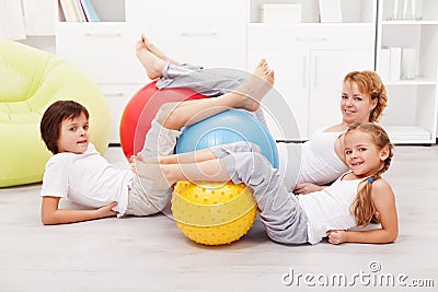 Happy healthy family with large gymnastic balls