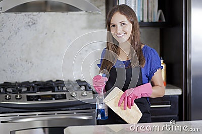 Happy housewife cleaning the kitchen