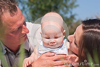 Happy husband and wife with the baby