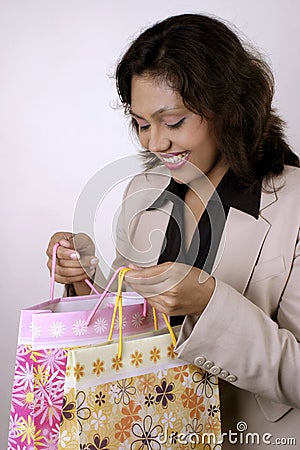 Happy Indian woman with shopping bags