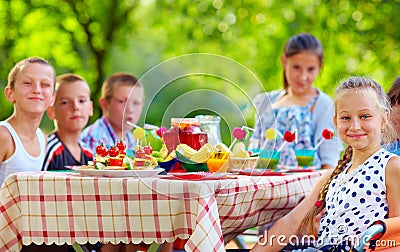 Happy kids around picnic table