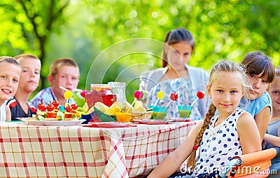 Happy kids around picnic table