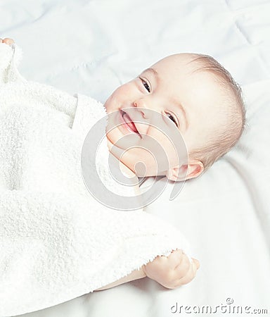 Happy, laughing baby after sleep. In the warm colors .