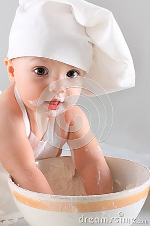 Happy little baby in a cook cap laughs