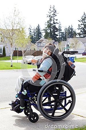 Happy little disabled boy in wheelchair