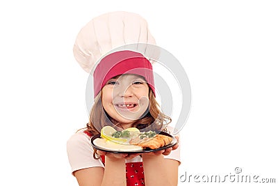 Happy little girl cook with salmon fish