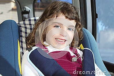 Happy little girl inside car security chair