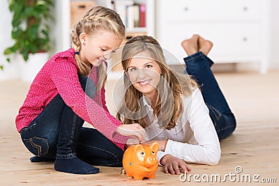 Happy little girl saving her pocket money