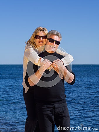 Happy loving middle-aged couple on beach
