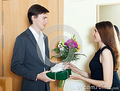 Happy man with flowers and gift box