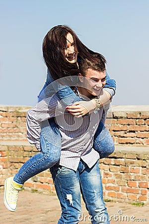 Happy man giving piggyback ride to woman