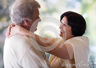 Happy mature couple embracing or dancing