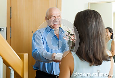 Happy mature man giving jewel in box to woman