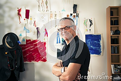 Happy mature man working as fashion designer