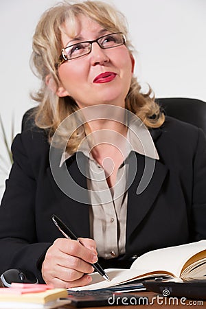 Happy middle aged businesswoman, at the desk