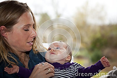 Happy mother admiring baby girl