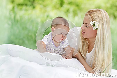 Happy mother and baby on natural background