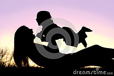 Happy Mother and Baby Playing Outside Silhouette