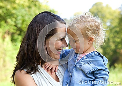 Happy mother and baby smiling face to face