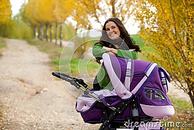 Happy mother with baby in stroller