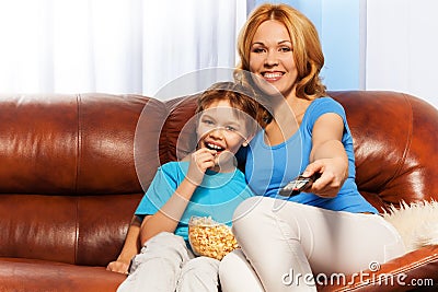 Happy mother and child sitting watching TV