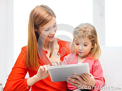 Happy mother and daughter with tablet pc computer