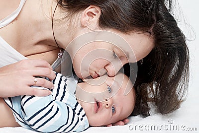 Happy mother kissing baby