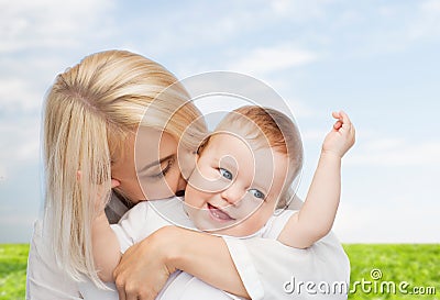 Happy mother kissing smiling baby