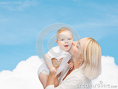 Happy mother kissing smiling baby