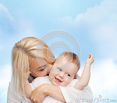 Happy mother kissing smiling baby