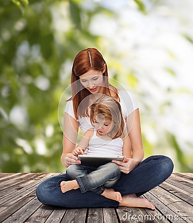 Happy mother with little girl and tablet pc