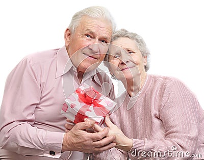 Happy old couple and box with gift