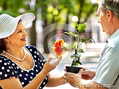 Happy old couple with flower.