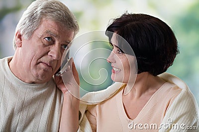 Happy old couple on mobile phone