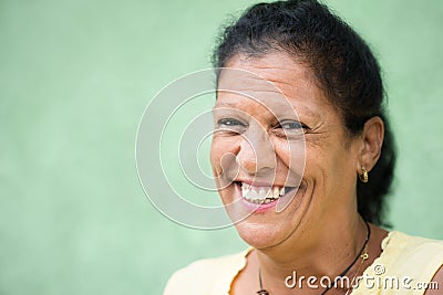 Happy old hispanic woman smiling at camera
