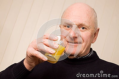 Happy older man with glass of juice